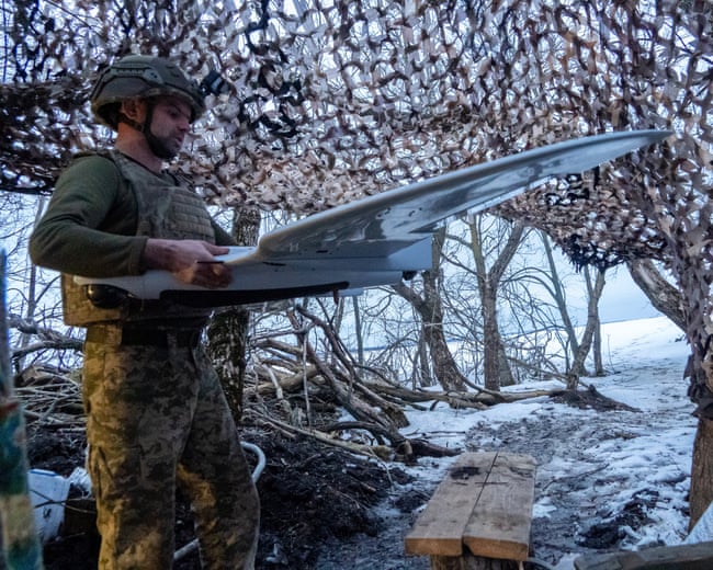 A Ukrainian soldier holding a drone