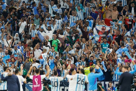 The Argentina players celebrate their victory with their fans.