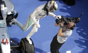 Mercedes driver Lewis Hamilton of Britain jumps off his car to celebrate after winning the Hungarian Formula One Grand Prix at the Hungaroring racetrack near Budapest, Hungary, Sunday, July 24, 2016.(AP Photo/Luca Bruno)