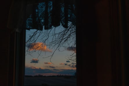 The sunset and vast cornfields are seen from the home the family shares with Tom’s father in New Lenox, Illinois.
