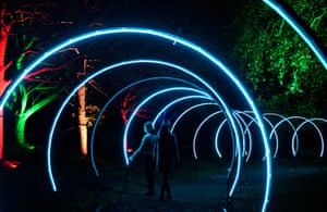 Visitors view light installations as part of the Enchanted Woodland illuminated trail at Syon Park in London, UK