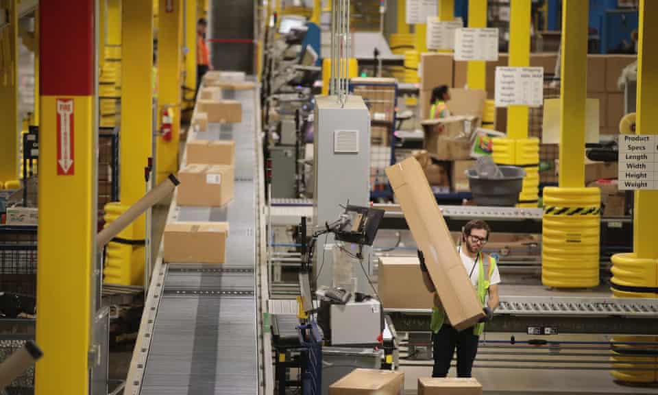 Workers pack and ship customer orders at the Amazon fulfillment center Romeoville, Illinois on 1 August 2017.
