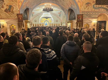 Men inside an ornate hall in the cathedral