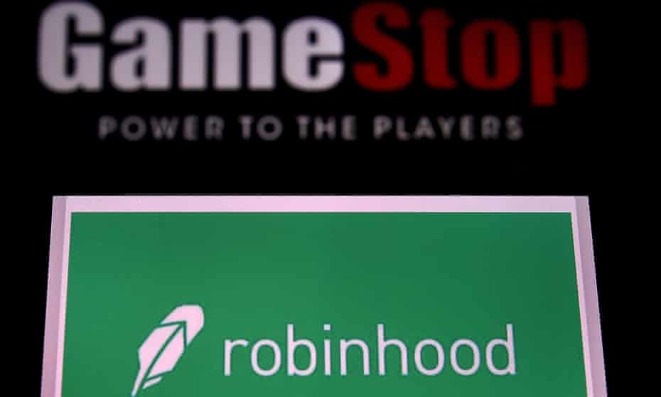 The logos of video game retail store GameStop and trading application Robinhood in a computer and on a mobile phone