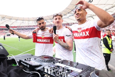 Jamie Leweling (right) wearing sunglasses displaying the text ‘Champions League’, fire up some tunes to celebrate with teammates Deniz Undav (left) and Angelo Stiller.