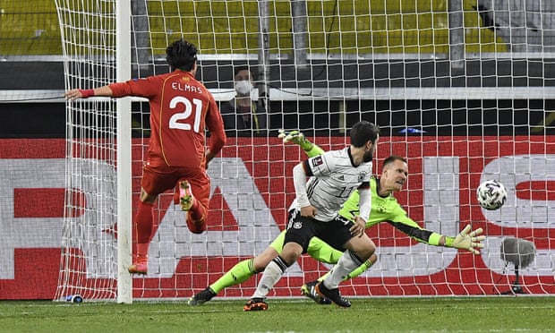Eljif Elmas (left) scores the decisive second goal for North Macedonia against Germany.