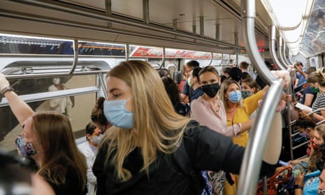 People wear masks while riding on the subway as cases of the infectious coronavirus Delta variant continue to rise in New York City.