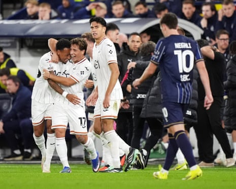 Ronald (left) celebrates scoring a late winner for Swansea in their game at Millwall