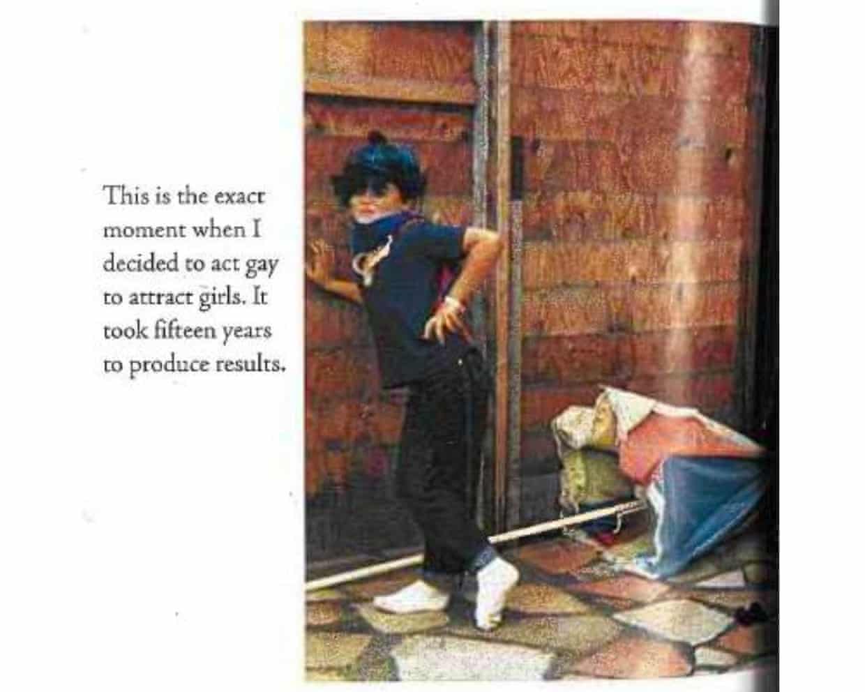 A young Russell Brand poses in sunglasses and a headscarf, leaning against a wooden wall, in a photograph from his book My Booky Wook.