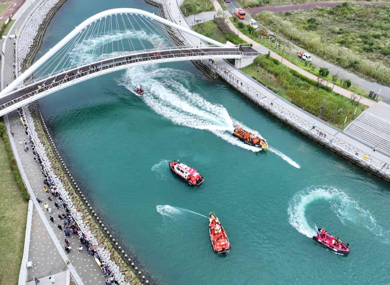 Aerial view of South Korean coastguard boats spraying water in an attempt to guide the shark back to the sea.