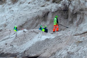 Zimbabweans work on a mined beach in Stanley