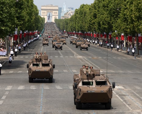 Armored vehicles are driven on Champs-Elysees Avenue during the Bastille Day military parade in Paris, France.