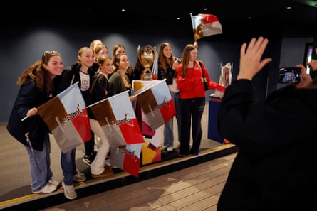 Fans pose alongside the Women’s World Cup trophy