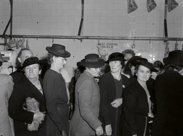 Black and white photograph of 1940s women and men in line at a butcher