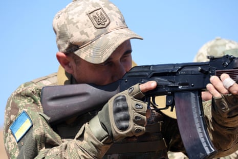 A member of service personnel holds a rifle during a training session of the national guard.