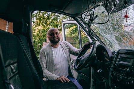 Marushchak with the van they used to use, showing the damage it sustained in a drone strike in the Kherson region.