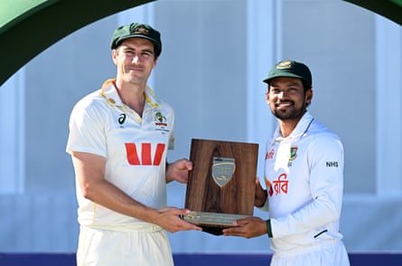 Australian captain Pat Cummins and Bangladesh captain Najmul Hossain Shanto share the series trophy
