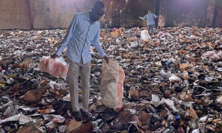 People salvaging items from a destroyed medical storage building