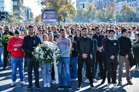 Mourners wait to lay flowers