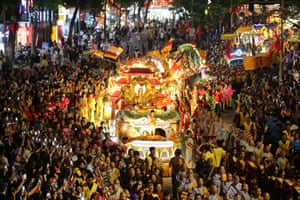 People gathered to watch a procession of floats carrying Buddha relics during the Vesak celebrations