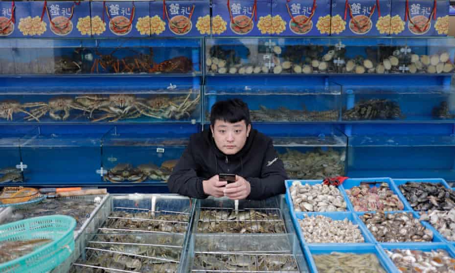 A vendor waits for customers at a market in Beijing