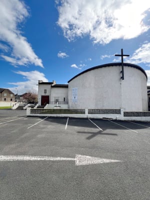 A white modernist church with a rounded roof