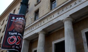 German finance minister Wolfang Schäuble is depicted on a no poster outside Bank of Greece in central Athens.