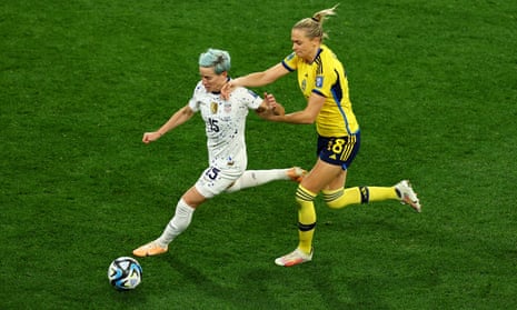 Megan Rapinoe is collared by Fridolina Rolfo.