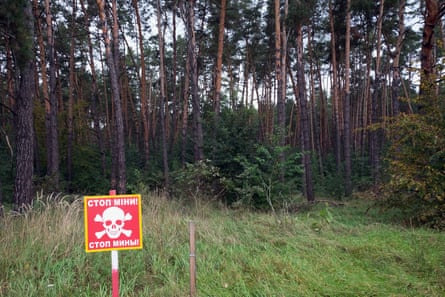 A sign about mining in the forest near the Ukrainian village of Zalissya, northeast of Kyiv.