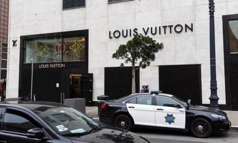 A police car sits outside the boarded-up windows of the Louis Vuitton store in San Francisco's Union Square.