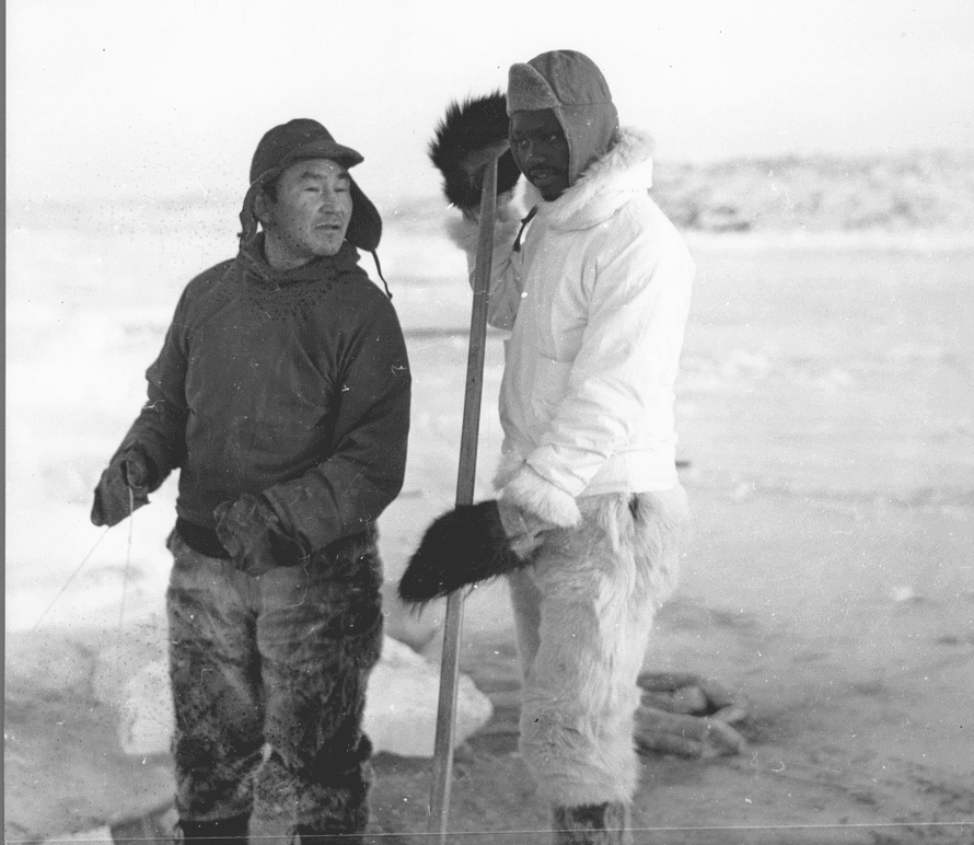 Tété Michel-Kpomassie learning to ice fish with a local.