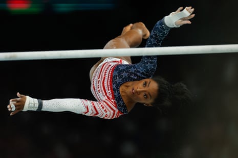 Upside down athlete pictured reaching for bar in mid-air.