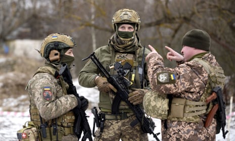 Three armed Ukrainian servicemen pictured during large-scale military exercises in the Chonobyl Exclusion Zone, Kyiv region, northern Ukraine.