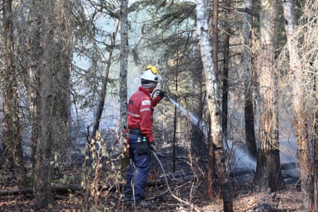 A handout photo made available by Alberta Wildfire showing a firefighter at one of scores of wildfires burning across multiple Canadian Provinces in Sturgeon Lake Cree Nation, Alberta, Canada, 08 June 2023.