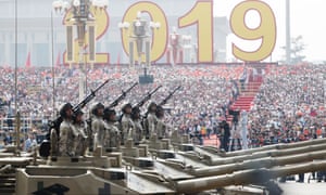 Chinese troops on military tanks roll past Tiananmen Square