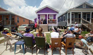 People gather to listen to music in front of a home at the Musicians Village