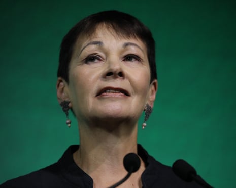 Caroline Lucas speaking against a Green backdrop