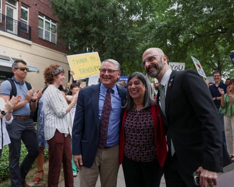 Debra Houry, Demetre Daskalakis (right), and Daniel Jernigan pose as they join a protest outside CDC campus in Atlanta, a day after the White House fired CDC director Susan Monarez.