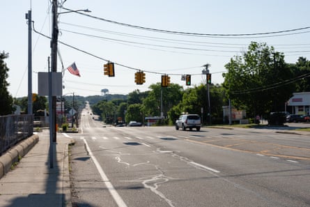 A car drives down an otherwise empty road