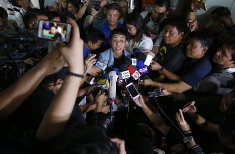 Maria Ressa, center, talks to the media after posting bail at a Regional Trial Court following an overnight arrest 