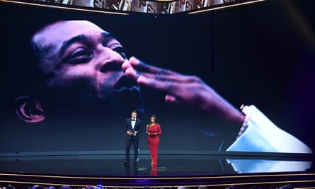 Hosts Jermaine Jenas and Samantha Johnson speak to the audience in front of an image of Pelé.