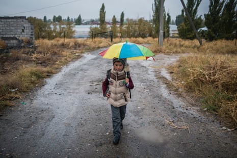 A boy from the Ak-Zhar novostroika walks across scrubland to school in Ak-Bata