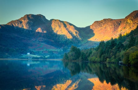 Sunrise on mountain range behind a reservoir