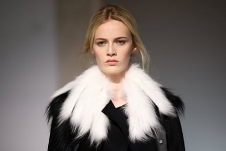 Head and shoulders shot of model with white fur-trimmed neck piece