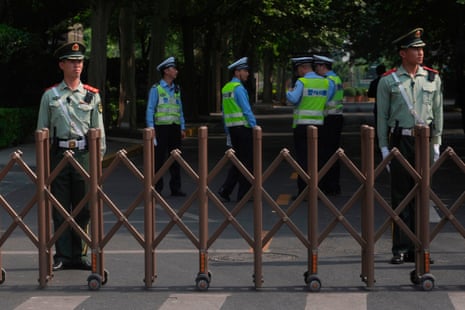 Chinese paramilitary police officers stand guard outside a hotel expected to be used for US president Donald Trump's visit.