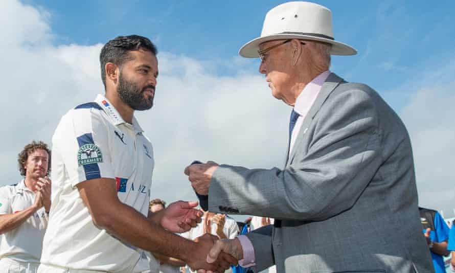 John Hampshire, as Yorkshire president, presents Azeem Rafiq with his county cap in 2016