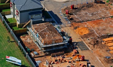 New house under construction, Holsworthy, Western Sydney, Aerial Photography<br>The timber frame of a new house under construction. This aerial photograph is from a series about Sydney's urban sprawl. The series features the creation of new suburbs, plus infrastructure like roads, parks and power lines. Urban sprawl in Sydney is a contentious issue with opinions divided on the need for the city to expand to house more people, compared to problems of spreading infrastructure and transport too thinly over an increasing area. Housing affordability in Sydney has also become a critical issue with people being unable to afford housing even on the edges of the city.