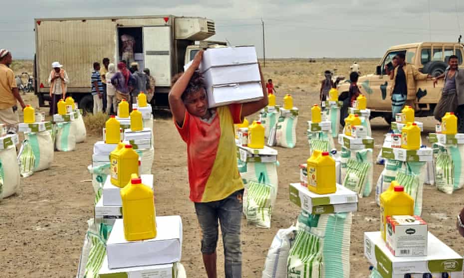 People displaced by conflict are receiving food aid donated by a Kuwaiti charity this week in the village of Hays, near the conflict zone in Yemen's western province of Hodeida.