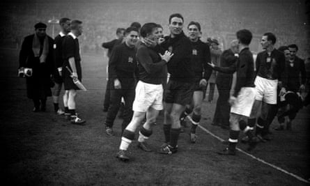 Football players on a pitch gather around each other