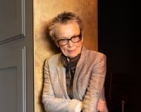 Laurie Anderson leans against a wall.
